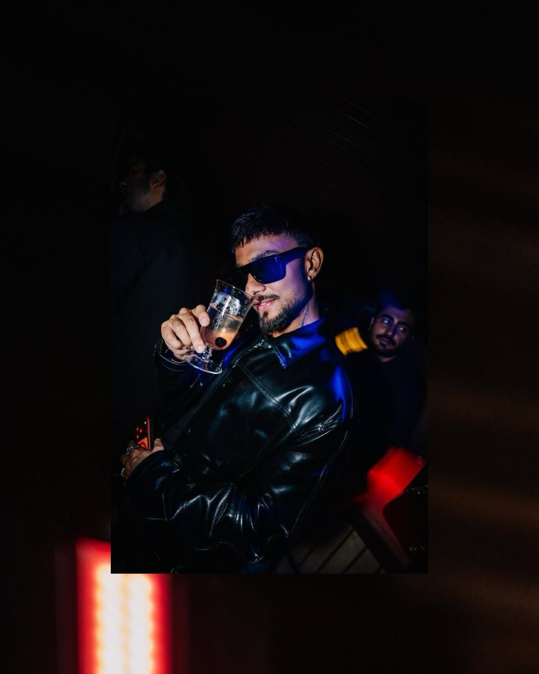 Guest in leather jacket sipping cocktail at the Tigerfire x BMW night