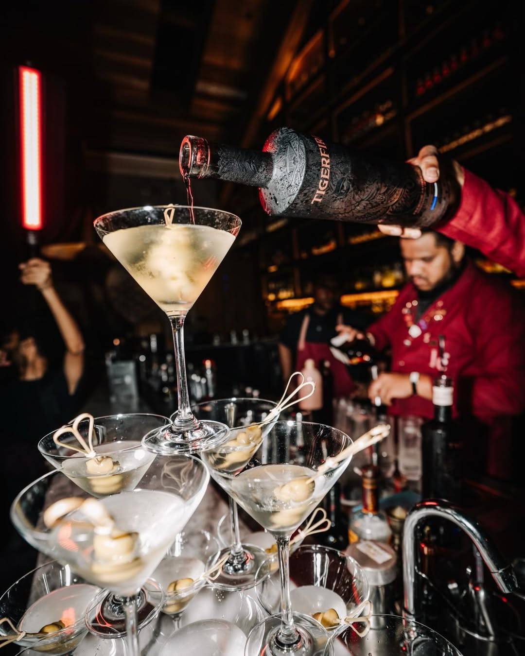 Tigerfire vodka being poured into a martini tower at the luxury bar crawl